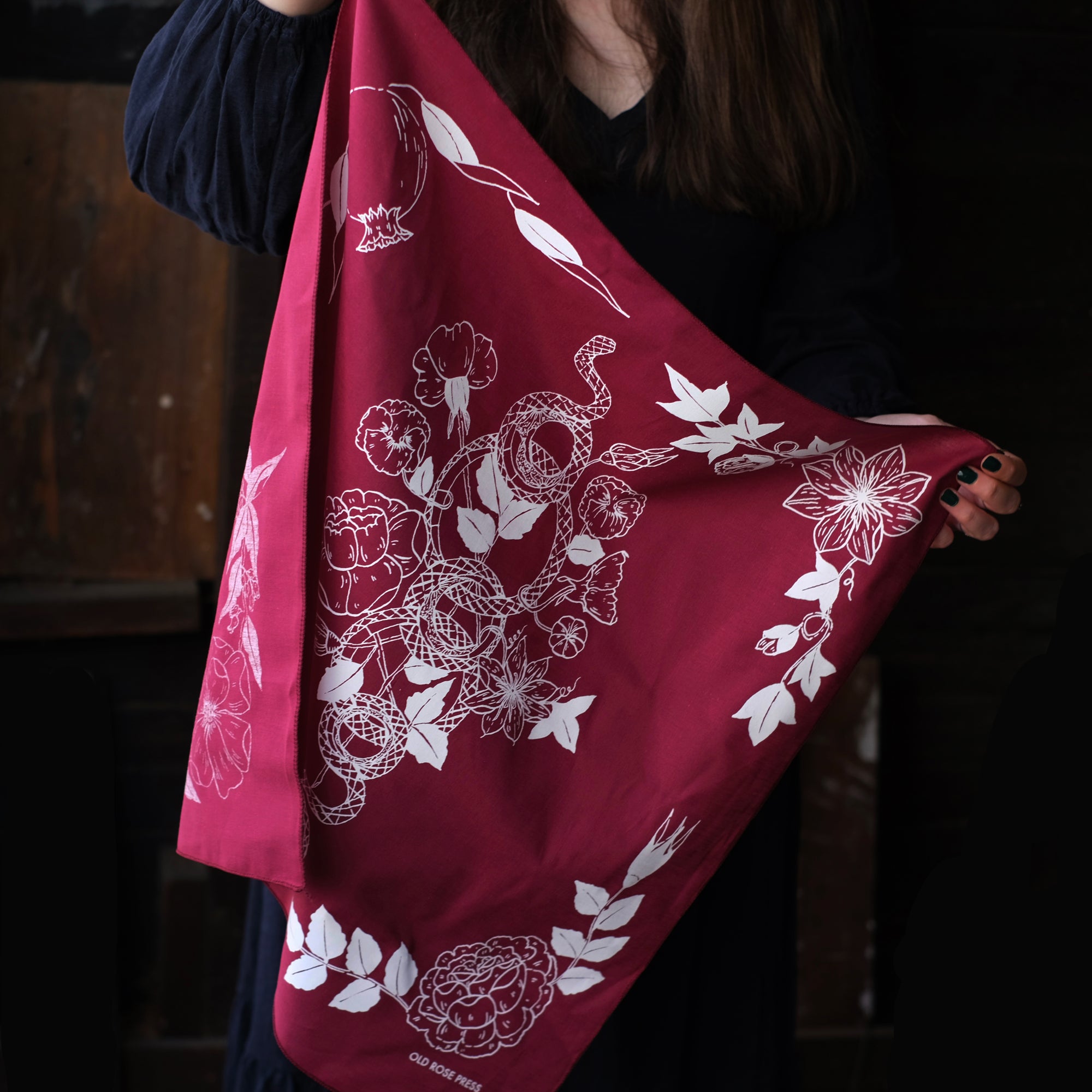 Serpent Garden Bandana reflects the botanicals throughout the four seasons, alongside a plant adorned snake. Artisan printed and illustrated by hand, to be used as an accessory or altar cloth. 